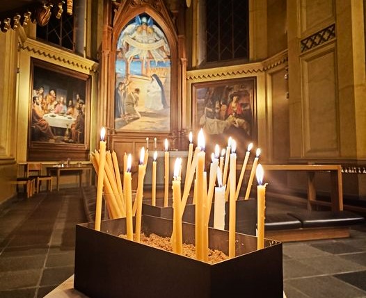Ljus i en låda med sand i en kyrka.