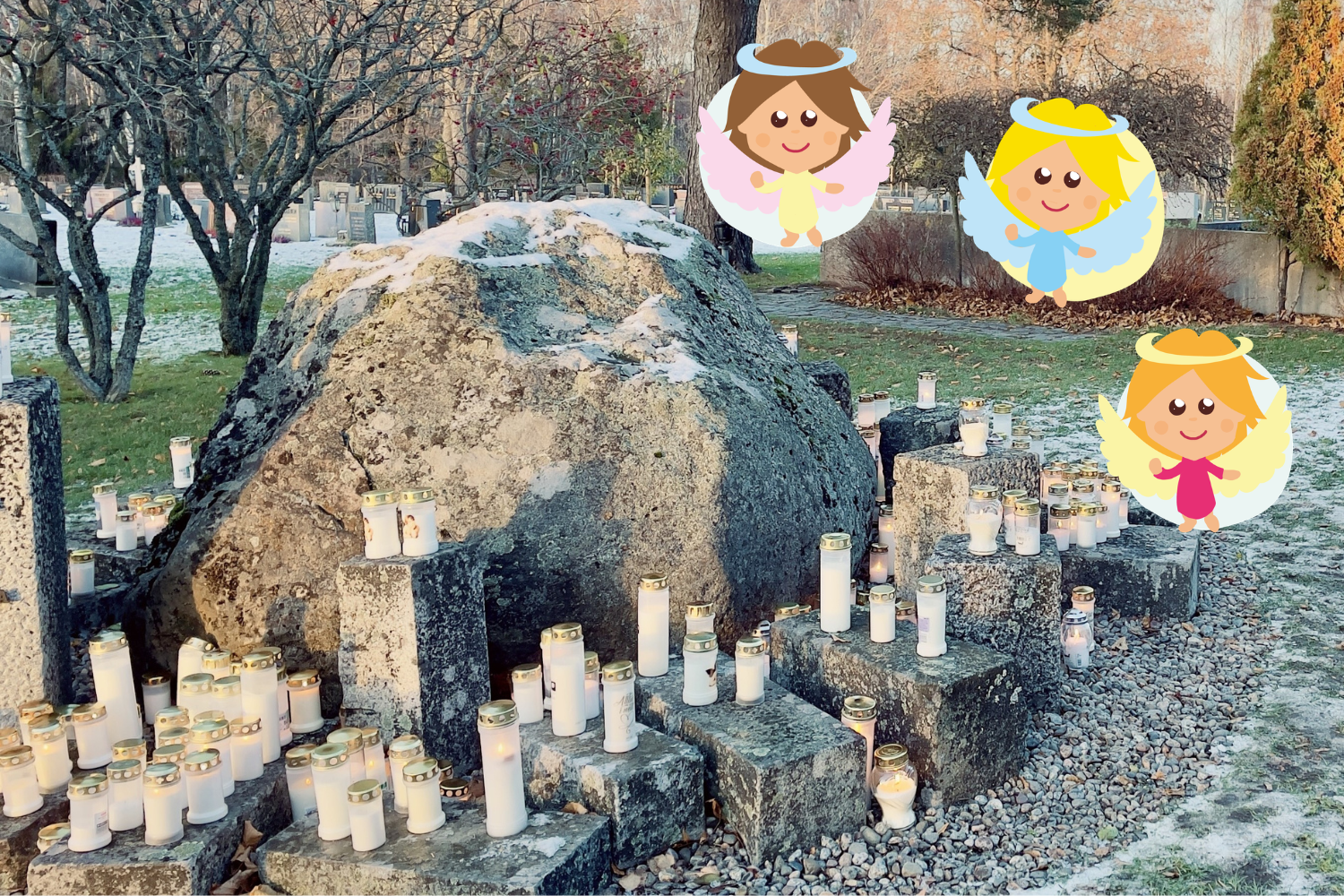Tända gravljus vid en sten. Tre små änglar.