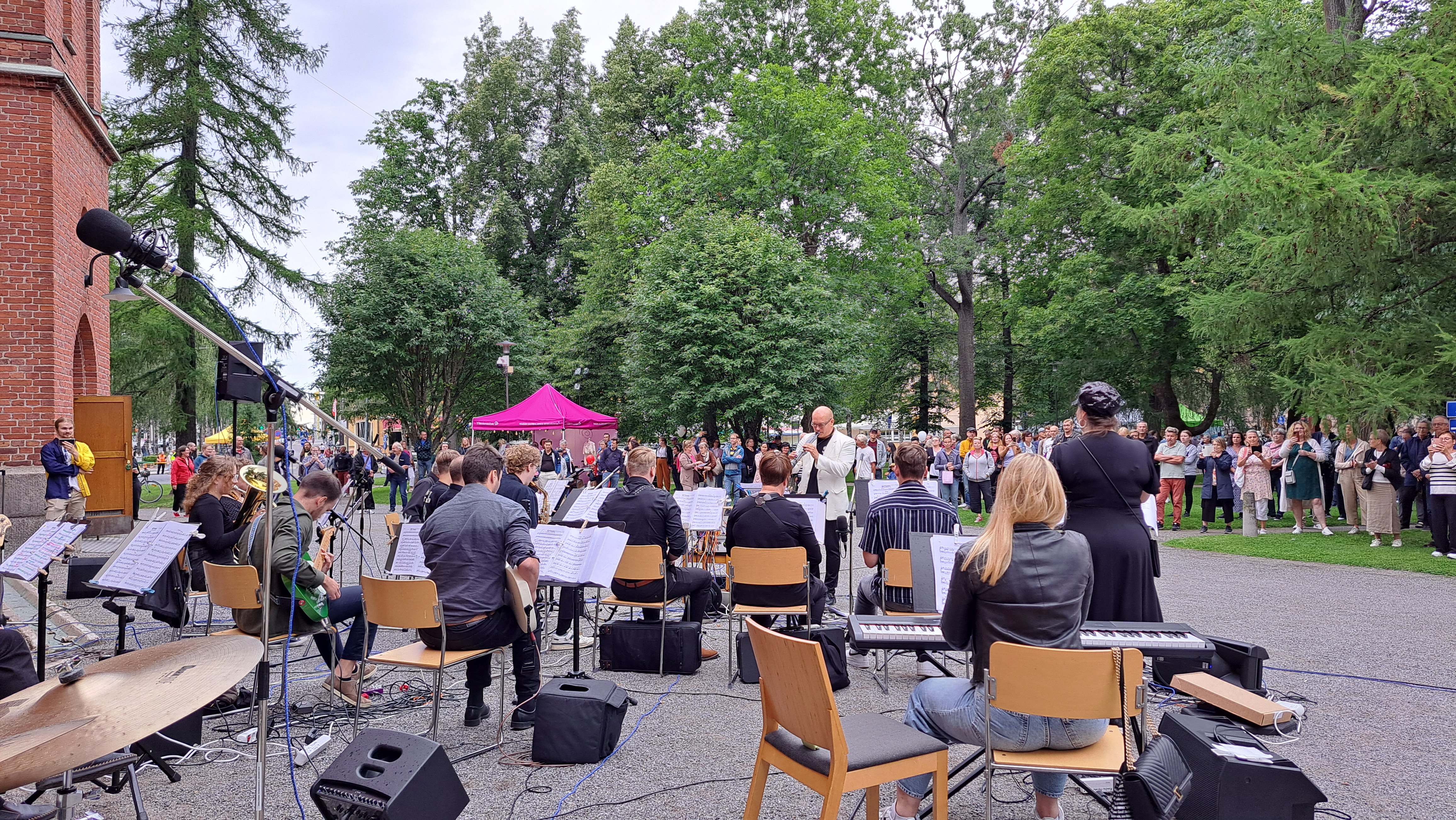 Band spelar i en park utanför en kyrka.